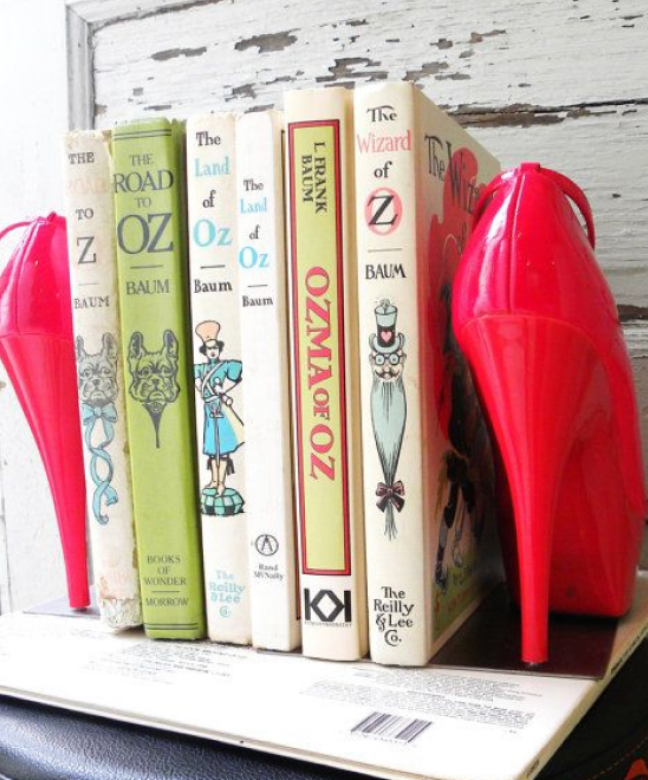 Using a pair of shoes as book ends on a shelf as a way to upcycle old high heels that are no longer desired.