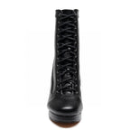 Front view of the Aadijay by Bailaqui, a black vegan leather high-heeled boot featuring a pointed toe and lace-up closure. The adjustable laces run through metal eyelets, adding to its sleek and fashionable design.