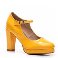 The Claudia - Yellow Vegan Patent - Street Sole is a single high heel shoe featuring a rounded closed toe, Mary Jane strap, chunky heel, and glossy finish to add flair to any ensemble.