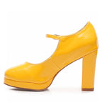 The Claudia Yellow Vegan Patent Mary Jane heels feature a chunky high heel and closed, rounded toe. A single strap crosses the top, and the street sole provides a bold, stylish appearance.